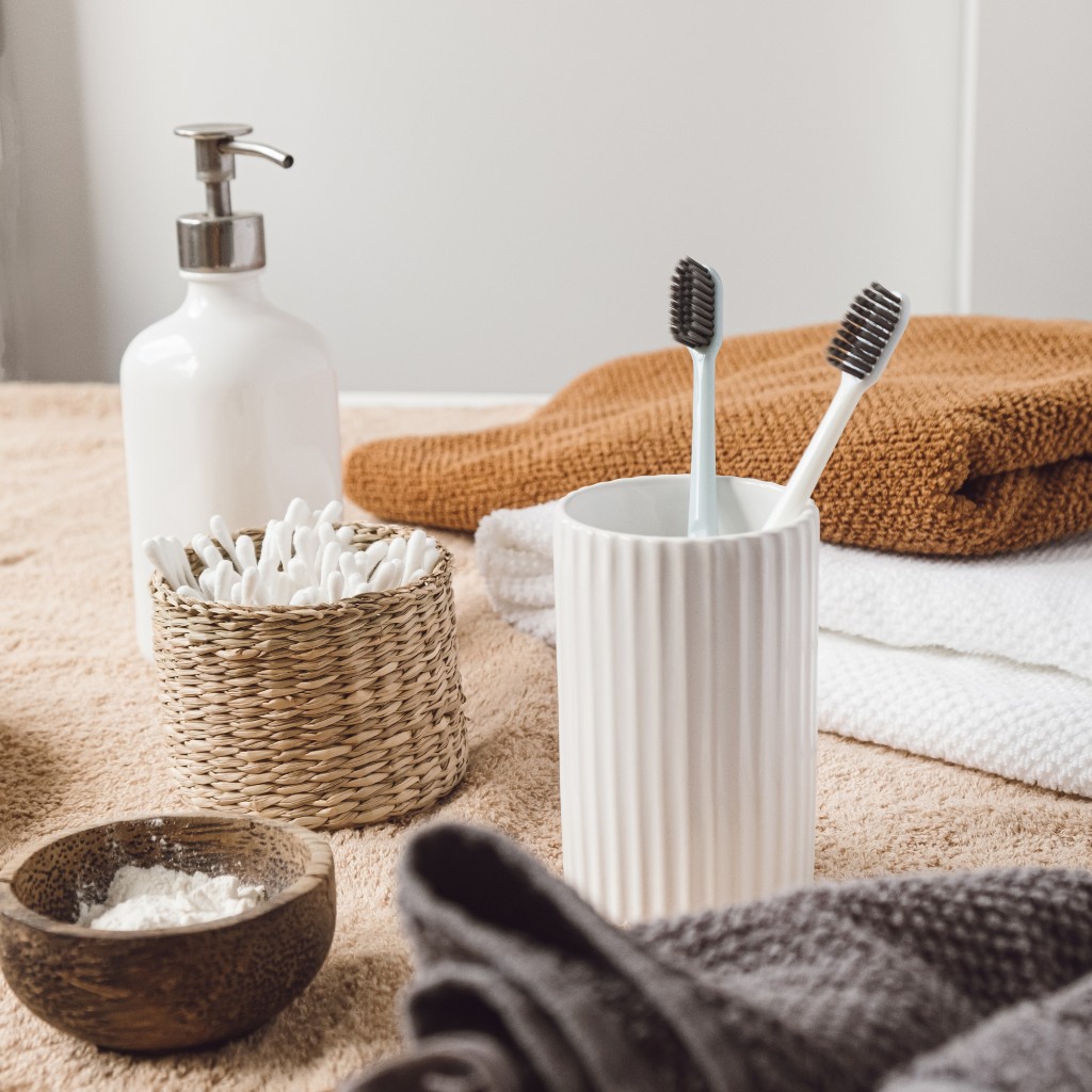 Warm bathroom shelf with soft towel and textured grooming essentials